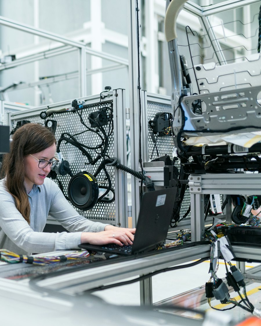 Engineer monitoring AI agent performance on a laptop in a lab